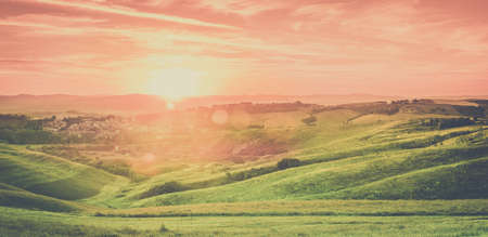 Amazing sunset over small tuscan town in Italyの写真素材