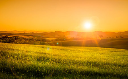 Sunrise over green tuscan hills in Italy