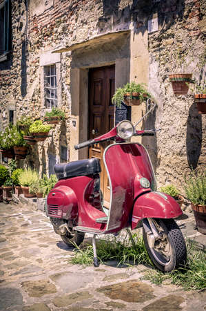 Scooter in front of old building in Cortona town, Tuscanyのeditorial素材