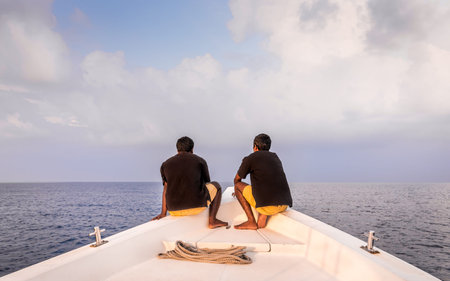 Two deckhands on a bow in Maldives