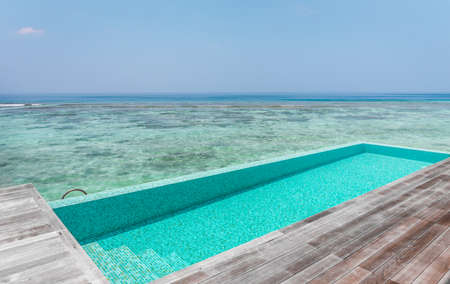 Private swimming pool and terrace of water villa in Maldivesの写真素材