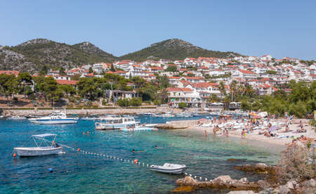 HVAR, CROATIA - JULY 30, 2016: People relaxing on a beach in Hvar village on Croatian Hvar islandのeditorial素材