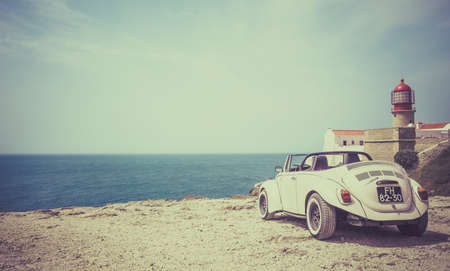 SAGRES, PORTUGAL - AUGUST 26, 2016: Classic cabrio car at Cape St. Vincent in Portugalのeditorial素材