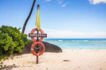 Life buoy on sandy beach in the Seychellesの写真素材
