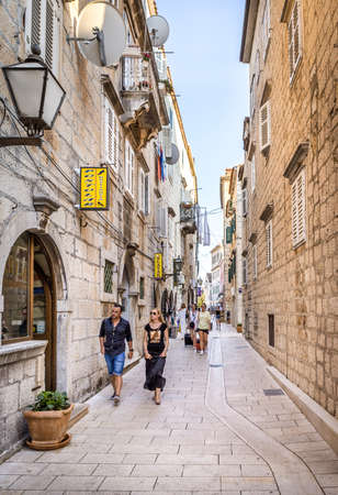 MAKARSKA, CROATIA - JULY 19, 2018: Tourists on narrow street of picturesque Makarska city, Croatiaのeditorial素材