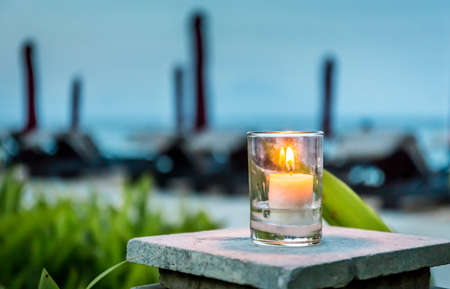 Candle in the evening with vivid colors backgroundの写真素材