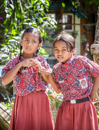 BALI, INDONESIA - APRIL 25, 2018: Young happy pupils wearing balinese school outfits at primary school on Bali island, Indonesiaのeditorial素材