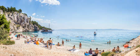 MAKARSKA, CROATIA - JULY 19, 21018: Tourists relaxing at marvelous Nugal beach near Makarska village, beautiful Mediterranean seascape, Croatiaのeditorial素材