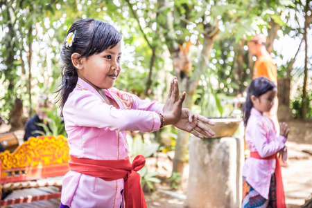 BALI, INDONESIA - APRIL 25, 2018: Small balinese dancers wearing beautiful outfits preparing for a performance on Bali Island, Indonesiaのeditorial素材