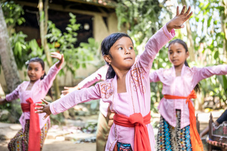 BALI, INDONESIA - APRIL 25, 2018: Small balinese dancers wearing beautiful outfits preparing for a performance on Bali Island, Indonesiaのeditorial素材