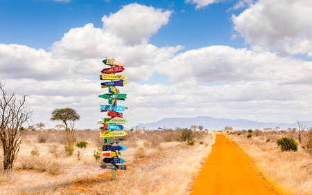 Funny different world directions signpost with distance to many different countriesの写真素材