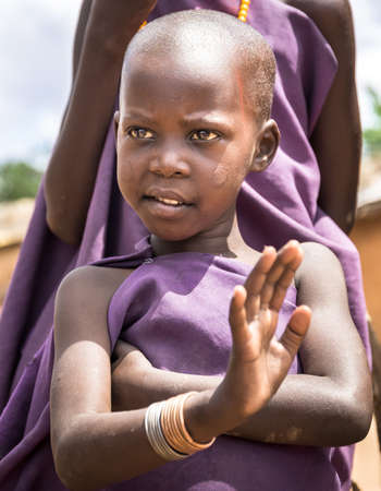 MASAI VILLAGE, KENYA - OCTOBER 11, 2018: Unindentified african child wearing traditional clothes in Masai tribe, Kenyaのeditorial素材