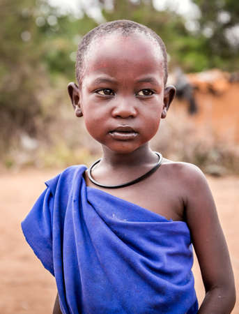 MASAI VILLAGE, KENYA - OCTOBER 11, 2018: Unindentified african child wearing traditional clothes in Masai tribe, Kenyaのeditorial素材