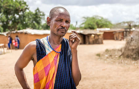MASAI VILLAGE, KENYA - OCTOBER 11, 2018: Unindentified african man wearing traditional clothes in Masai tribe, Kenyaのeditorial素材