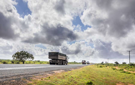 African highway from Mombasa to Nairobi in Kenya, straight asphalt road and surrounding plainsの写真素材