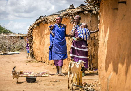 MASAI VILLAGE, KENYA - OCTOBER 11, 2018: Unindentified african women wearing traditional clothes in Masai tribe, Kenyaのeditorial素材