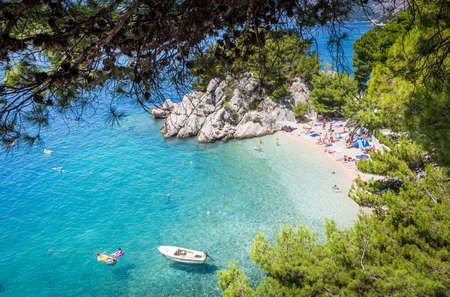 BRELA, CROATIA - JULY 20, 2018: Tourists relaxing on marvelous Brela beach, beautiful Mediterranean seascape in Croatiaのeditorial素材