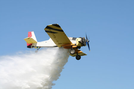 Airplane dropping water on a fire