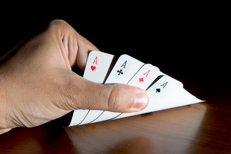 Hand Opening Playing Cards From Table