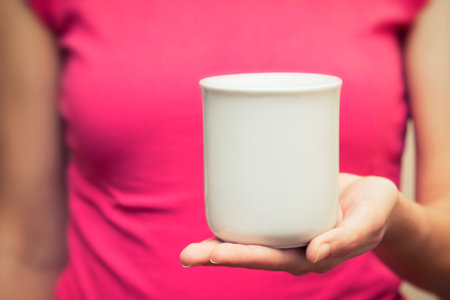 Woman Holding A Cup In Her Handの写真素材