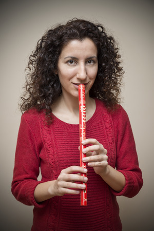 Woman Playing Wooden Fluteの写真素材