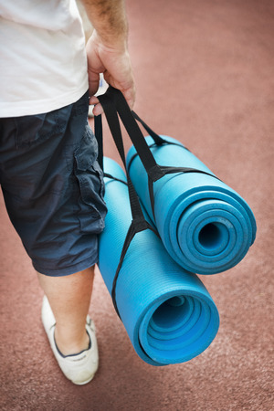 Man Holding Sports Mat For Outdoor Exerciseの写真素材