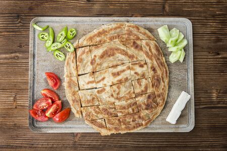 Traditional Turkish Borek Served With Tomatoes, Peppers, Cheese And Sliced ââCucumbersの写真素材