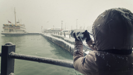 Photographer Trying To Shoot Under Heavy Snow, Istanbul, Turkeyの写真素材