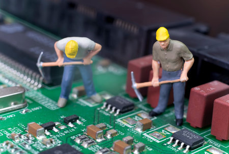Miniature Workers On Top Of Circuit Board