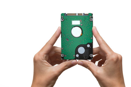 Female Hands Holding Small Hard Disk Drive, Isolated On White Background