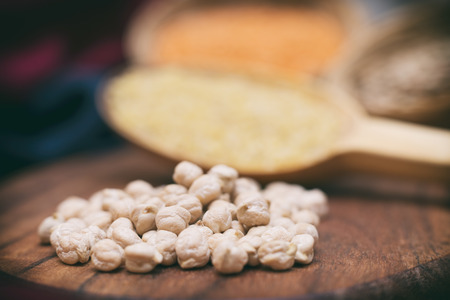 Heap Of Chickpeas On A Wooden Surface, Other Legumes On Backgroundの写真素材