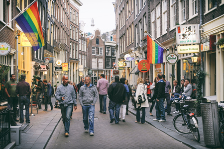 People walking at Zeedijk, a street in the old centre of Amsterdam. The street is the northern and eastern boundary of De Wallen. Famous with many bars. Amsterdam, Netherlands.のeditorial素材