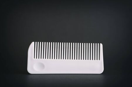 White Comb On A Dark Surfaceの写真素材