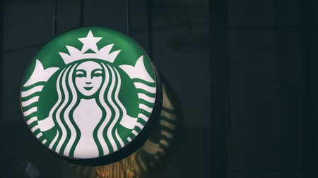 Close up shot of Starbucks Coffee Company, an American coffee company and coffeehouse chain. Starbucks was founded in Seattle, Washington in 1971.のeditorial素材