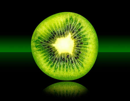Kiwi, Tropical Fresh Fruit on Mirrored Surface and Green to Black Faded Backgroundの写真素材