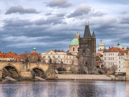Charles Bridge in Autumn Before Rain, Gray-Blue Cloudy Afternoon Weather, Prague - the Capital of the Czech Republicの写真素材