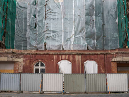 Reconstruction of an Old Apartment Building, Covered Scaffolding and a Closed off Street and Sidewalkの写真素材