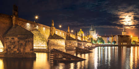 Panorama of Illuminated Charles Bridge, Cultural Monument of the Capital of the Czech Republic, Night Cityscape of the City Center with the Riverの写真素材