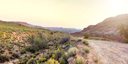 Beautiful, Inhospitable Landscape on the Border of Utah and Arizona, a Trail with Mesas, Plateaus on the Horizonの写真素材