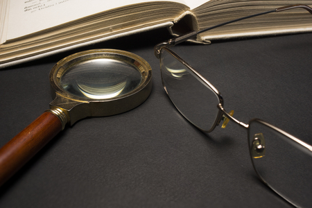 Ophthalmologist concept with book, eyeglasses and magnifying glass. High resolution image.の写真素材