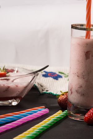 Strawberry smooothie with straberries in the background. High resolution image.の写真素材