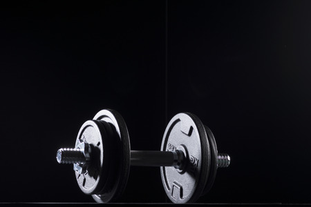 Bodybuilding weights concept on black background. High resolution image concept for bodybuiding or fitness industry.の写真素材