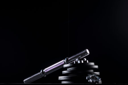 Bodybuilding weights concept on black background. High resolution image concept for bodybuiding or fitness industry.の写真素材
