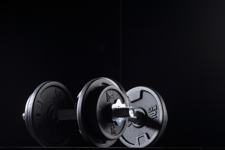 Bodybuilding weights concept on black background. High resolution image concept for bodybuiding or fitness industry.の写真素材