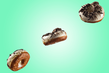 White chocolate glazed donut and chocolate topping on blue green background. High resolution image for food industry.の写真素材