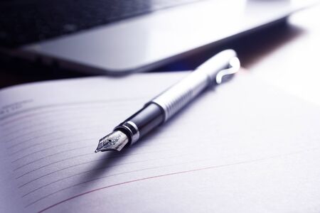 High resolution image, showing a desk working space, with laptop, agenda, pen, phone.の写真素材