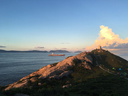 View of tourist camping along mountain peak to observe sunrise