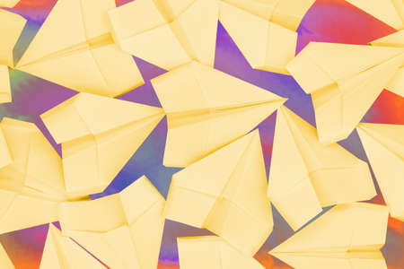 Colorful background with yellow paper airplanes. Origami concept isolated texture.の写真素材