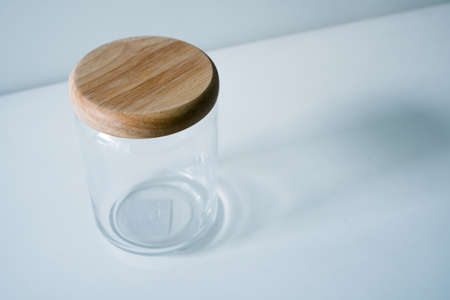 Glass jar on wooden white tableの写真素材