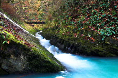 Waterfall with the bridge and the rockの写真素材